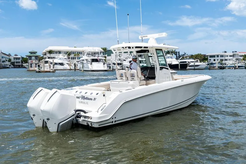  Yacht Photos Pics 2020 Boston Whaler 280 Outrage boat docked in marina, clear sky background.