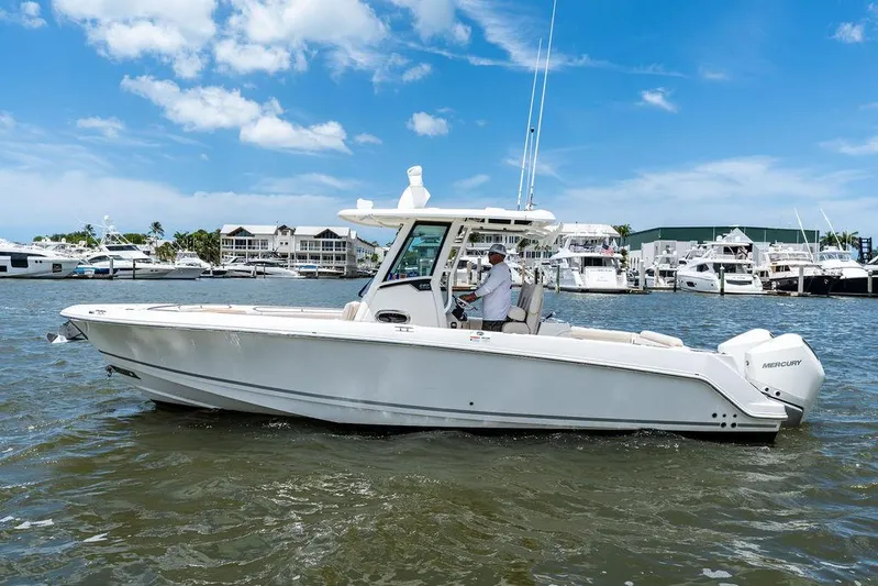  Yacht Photos Pics 2020 Boston Whaler 280 Outrage boat cruising on a sunny day near a marina.