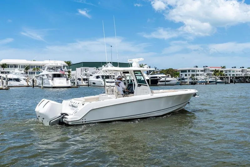 Yacht Photos Pics 2020 Boston Whaler 280 Outrage boat cruising in a marina with clear skies.
