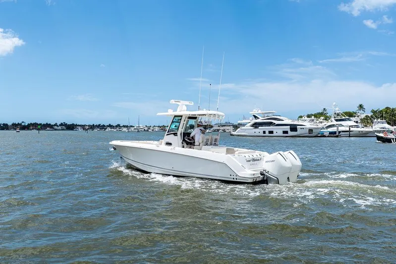  Yacht Photos Pics 2020 Boston Whaler 280 Outrage cruising on a sunny day with yachts in the background.