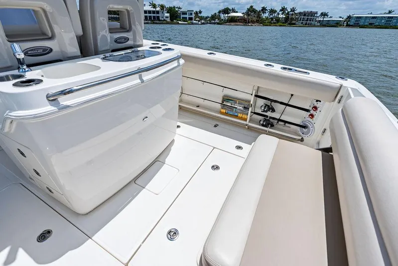  Yacht Photos Pics 2020 Boston Whaler 280 Outrage boat interior with seating and storage, near waterfront homes.
