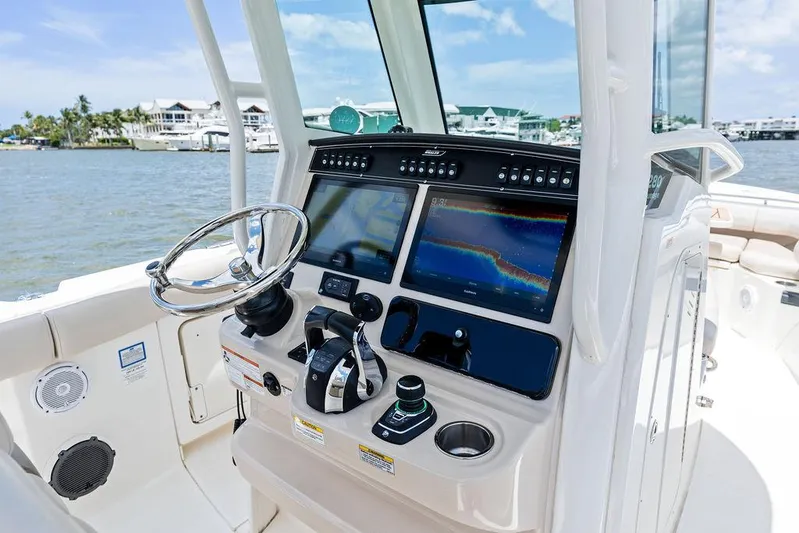  Yacht Photos Pics 2020 Boston Whaler 280 Outrage helm with dual displays and controls, dockside view.