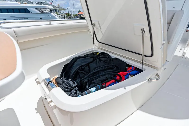  Yacht Photos Pics Open storage compartment on 2020 Boston Whaler 280 Outrage boat, containing gear and equipment.