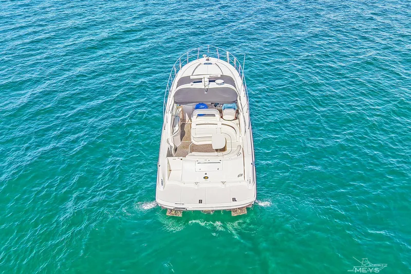 Yacht Photos Pics Aerial view of 2003 Sea Ray 420 Sundancer yacht on clear blue water.