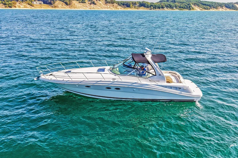  Yacht Photos Pics 2003 Sea Ray 420 Sundancer yacht cruising on clear blue water.