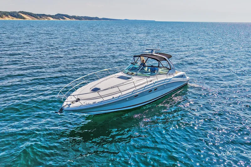  Yacht Photos Pics 2003 Sea Ray 420 Sundancer cruising on clear blue water under sunny skies.