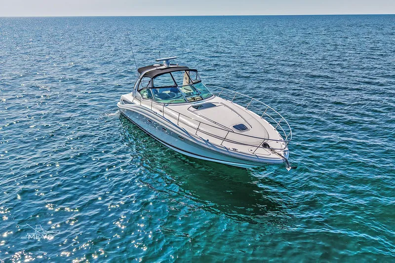  Yacht Photos Pics 2003 Sea Ray 420 Sundancer yacht cruising on clear blue ocean waters.