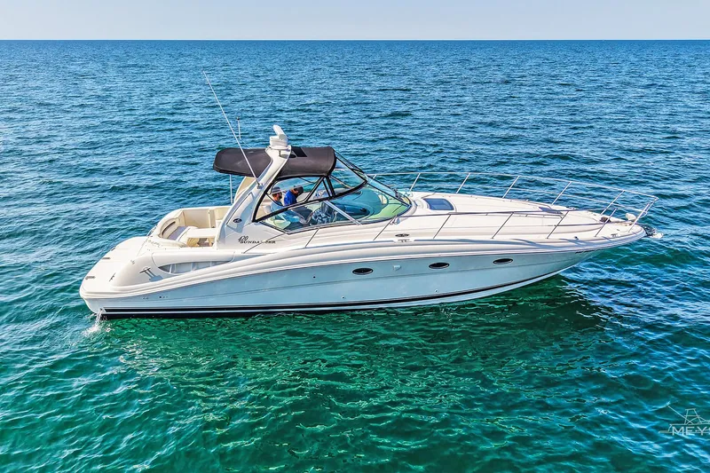  Yacht Photos Pics 2003 Sea Ray 420 Sundancer yacht cruising on open blue water.