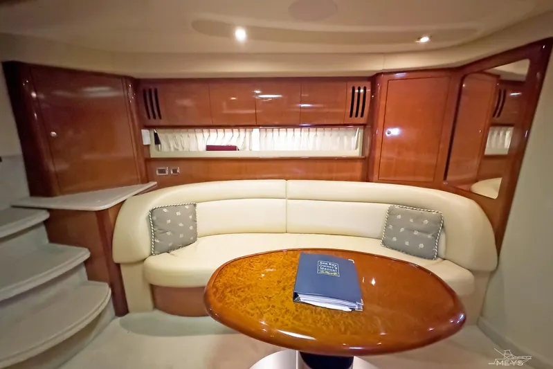  Yacht Photos Pics Luxurious interior of 2003 Sea Ray 420 Sundancer yacht with elegant seating and wooden table.
