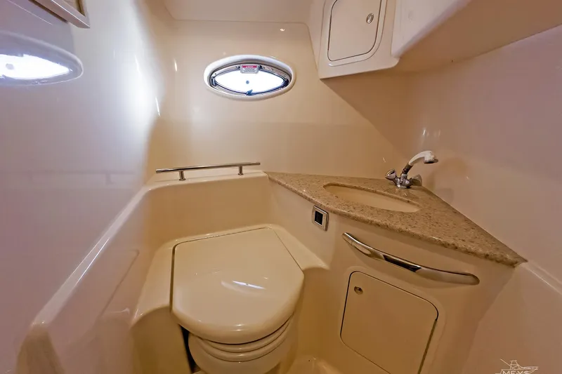  Yacht Photos Pics 2003 Sea Ray 420 Sundancer bathroom with toilet, sink, and porthole window.