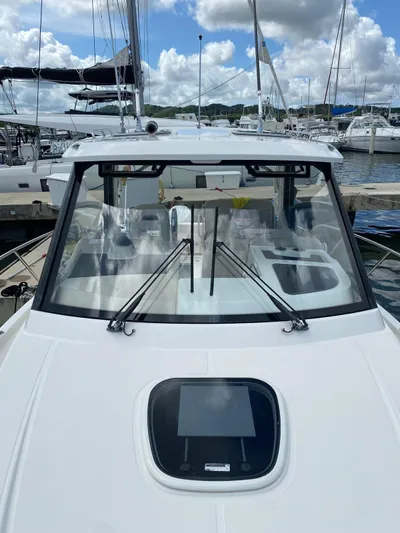  Yacht Photos Pics 2021 Boston Whaler 325 Conquest docked, showcasing sleek design and spacious deck.