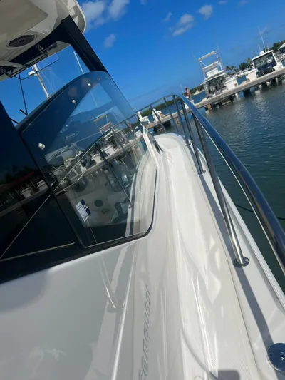  Yacht Photos Pics 2021 Boston Whaler 325 Conquest docked, showcasing sleek design and marina view.
