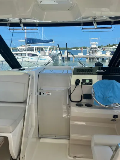  Yacht Photos Pics Interior view of a 2021 Boston Whaler 325 Conquest boat docked at a marina.