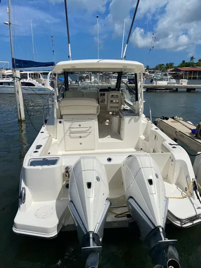  Yacht Photos Pics 2021 Boston Whaler 325 Conquest boat docked at marina under blue sky.