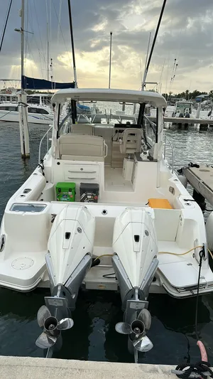  Yacht Photos Pics 2021 Boston Whaler 325 Conquest docked at marina, featuring dual outboard engines.
