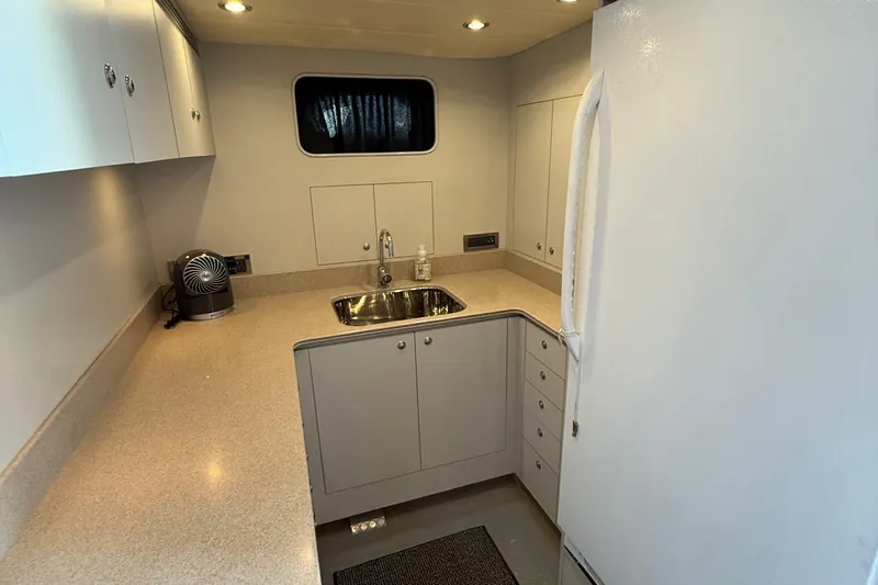 Wishlist Yacht Photos Pics Compact kitchen in a 2009 Horizon 73 yacht with modern appliances and sleek cabinetry.