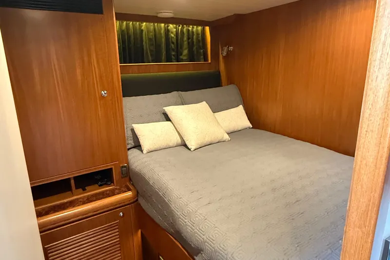 Wishlist Yacht Photos Pics Cozy cabin interior of 2009 Horizon 73 yacht with wooden paneling and comfortable bedding.