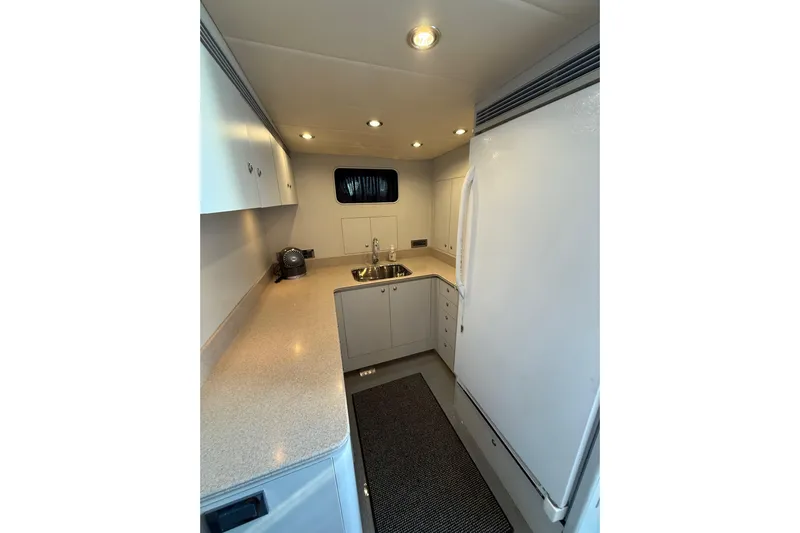 Wishlist Yacht Photos Pics Compact kitchen interior of 2009 Horizon 73 yacht with modern appliances and sleek design.