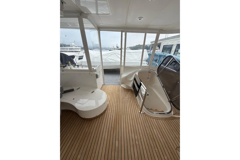 Wishlist Yacht Photos Pics Interior view of a 2009 Horizon 73 yacht with wooden flooring and seating area.