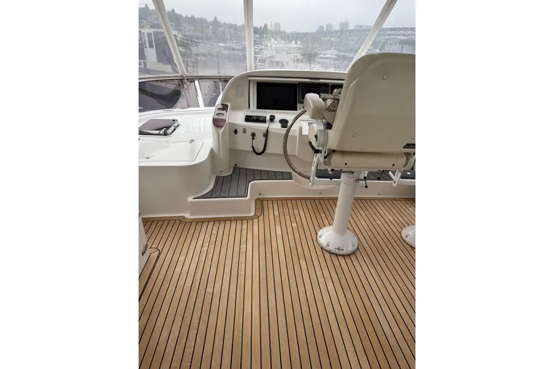 Wishlist Yacht Photos Pics Helm of 2009 Horizon 73 yacht with wooden deck and navigation controls.