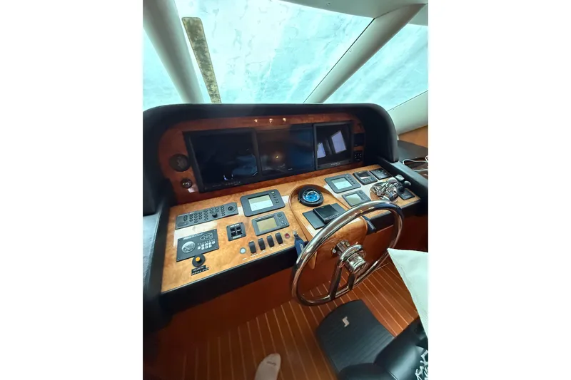 Wishlist Yacht Photos Pics Helm of 2009 Horizon 73 yacht with navigation controls and steering wheel.