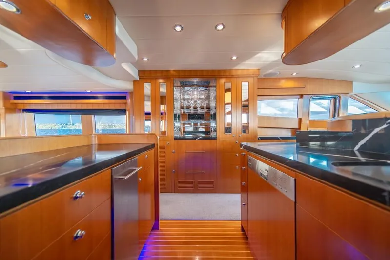 Wishlist Yacht Photos Pics Luxurious interior of 2009 Horizon 73 yacht with modern kitchen and wooden cabinetry.