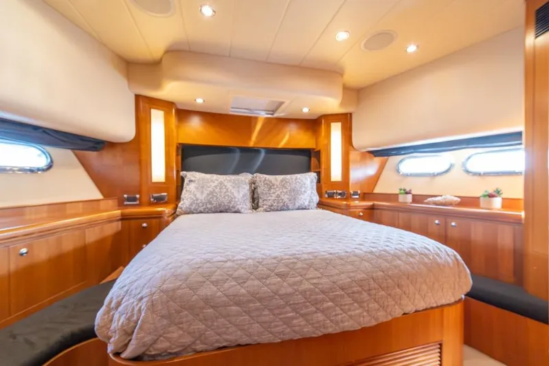 Wishlist Yacht Photos Pics Luxurious bedroom interior of 2009 Horizon 73 yacht with elegant wood paneling and cozy bedding.