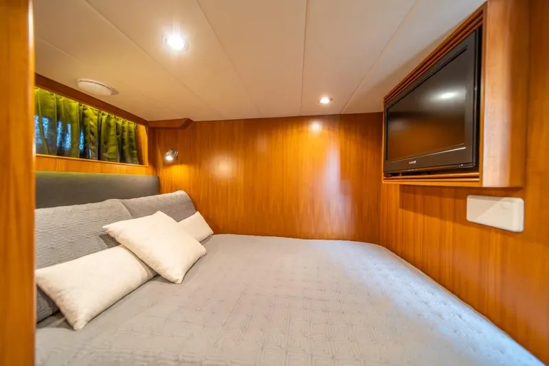 Wishlist Yacht Photos Pics Luxurious cabin interior of 2009 Horizon 73 yacht with cozy bed and mounted TV.
