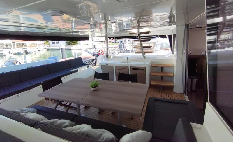 Jarana Yacht Photos Pics Spacious Lagoon 620 yacht interior with dining area, modern seating, and elegant design, 2012 model.