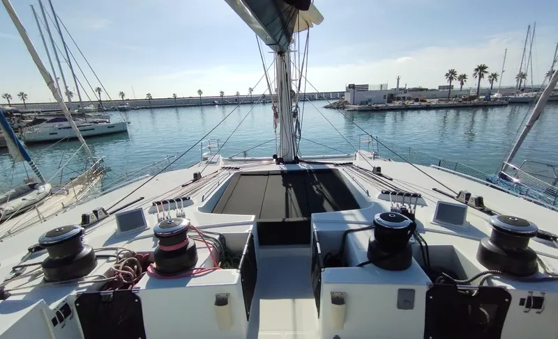 Jarana Yacht Photos Pics Lagoon 620 yacht deck, 2012 model, docked in a sunny marina with palm trees.