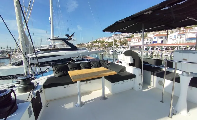 Jarana Yacht Photos Pics Luxurious Lagoon 620 yacht deck with seating area, docked in a sunny marina, 2012 model.