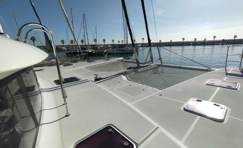 Jarana Yacht Photos Pics Deck view of 2012 Lagoon 620 catamaran docked at marina under clear sky.