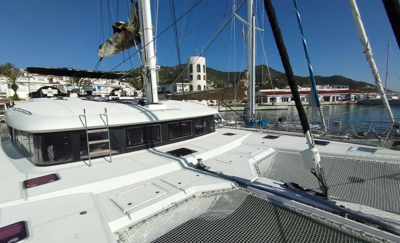 Jarana Yacht Photos Pics Lagoon 620 catamaran docked at marina, 2012 model, with clear blue sky background.