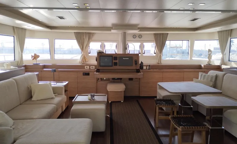 Jarana Yacht Photos Pics Luxurious interior of a 2012 Lagoon 620 yacht with elegant seating and large windows.