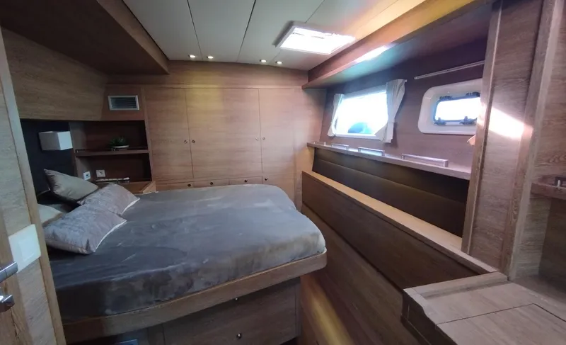 Jarana Yacht Photos Pics Luxurious cabin interior of a 2012 Lagoon 620 yacht with wood finishes and natural light.