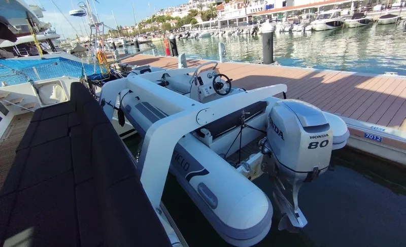 Jarana Yacht Photos Pics Lagoon 620 catamaran docked at marina, featuring Honda outboard motor, 2012 model.