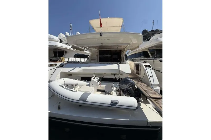  Yacht Photos Pics 2013 Ferretti Yachts 720 with inflatable boat and Yamaha motor, docked under clear sky.
