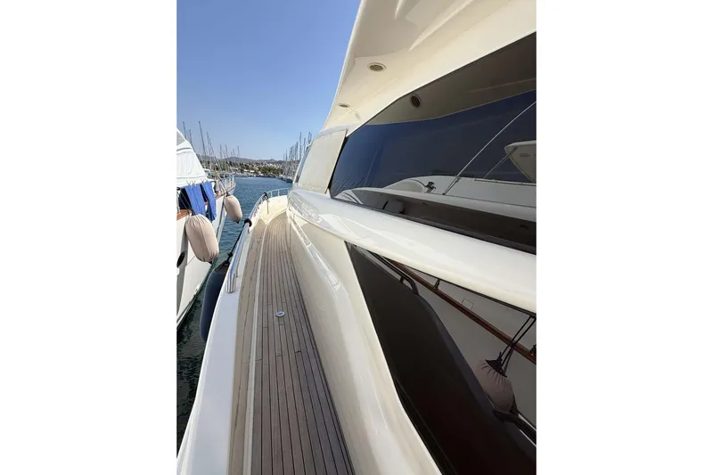  Yacht Photos Pics Side view of 2013 Ferretti Yachts 720, showcasing sleek design and wooden deck.