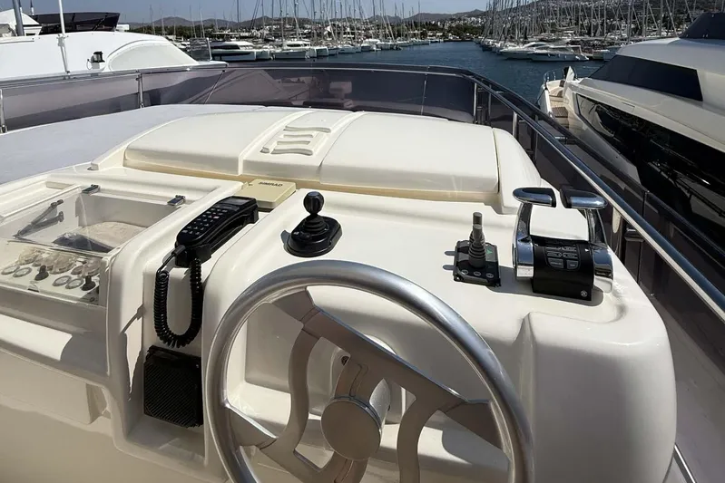  Yacht Photos Pics Control panel of a 2013 Ferretti Yachts 720, featuring steering wheel and navigation equipment.