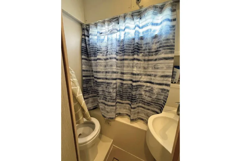  Yacht Photos Pics Bathroom interior of 2013 Ferretti Yachts 720 with striped shower curtain.