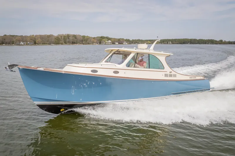 Just B Yacht Photos Pics 2018 Hinckley Picnic Boat MKII cruising on a calm lake.