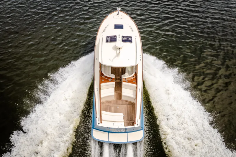 Just B Yacht Photos Pics 2018 Hinckley Picnic Boat MKII cruising on water, aerial view.
