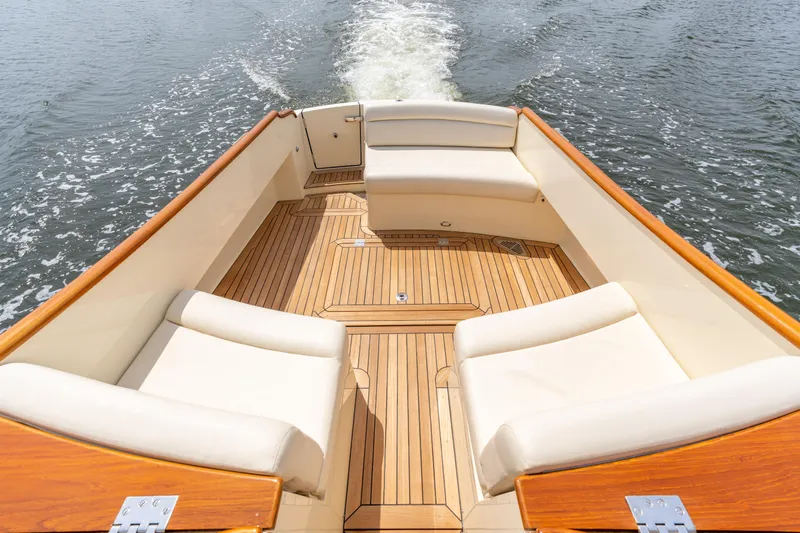 Just B Yacht Photos Pics Hinckley Picnic Boat MKII 2018, elegant deck with cushioned seating on water.