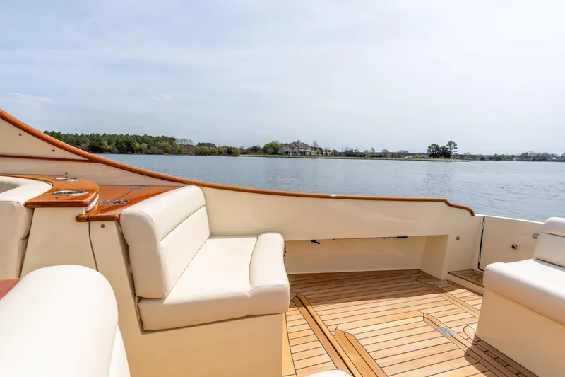 Just B Yacht Photos Pics 2018 Hinckley Picnic Boat MKII interior with lake view, featuring elegant seating and wooden deck.