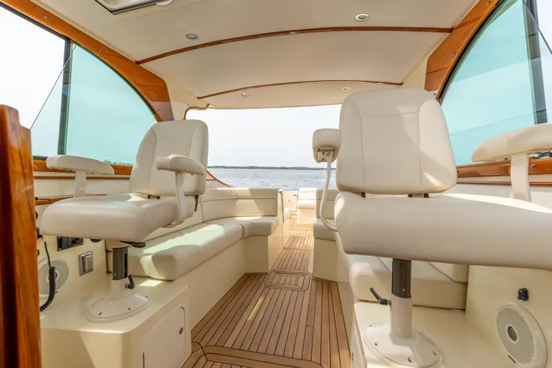 Just B Yacht Photos Pics Interior of 2018 Hinckley Picnic Boat MKII with elegant seating and wooden flooring.