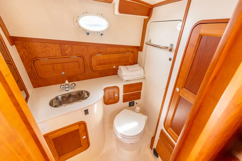 Just B Yacht Photos Pics 2018 Hinckley Picnic Boat MKII bathroom with wood accents and modern fixtures.