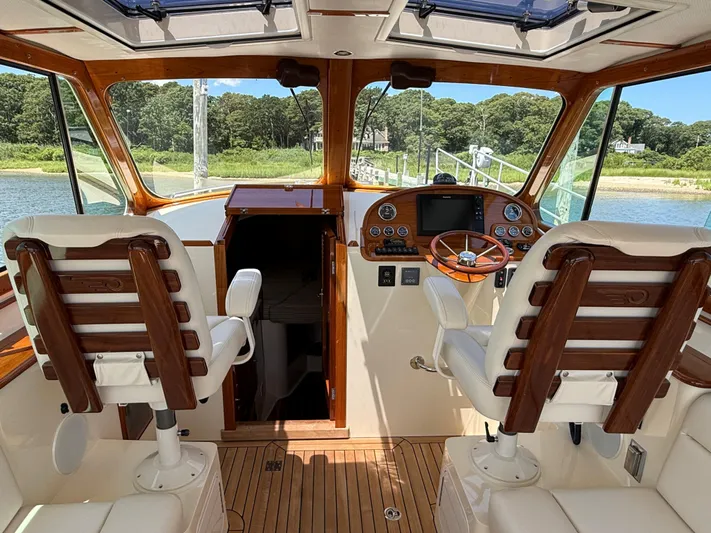 Just B Yacht Photos Pics Interior of 2018 Hinckley Picnic Boat MKII with wooden helm and leather seats.