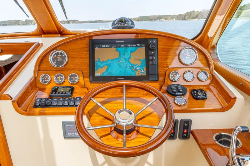 Just B Yacht Photos Pics Helm of 2018 Hinckley Picnic Boat MKII with navigation display and wooden steering wheel.