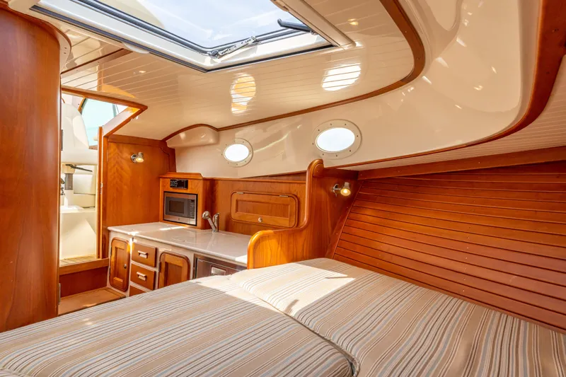 Just B Yacht Photos Pics Interior of 2018 Hinckley Picnic Boat MKII with wood finish and compact kitchen.