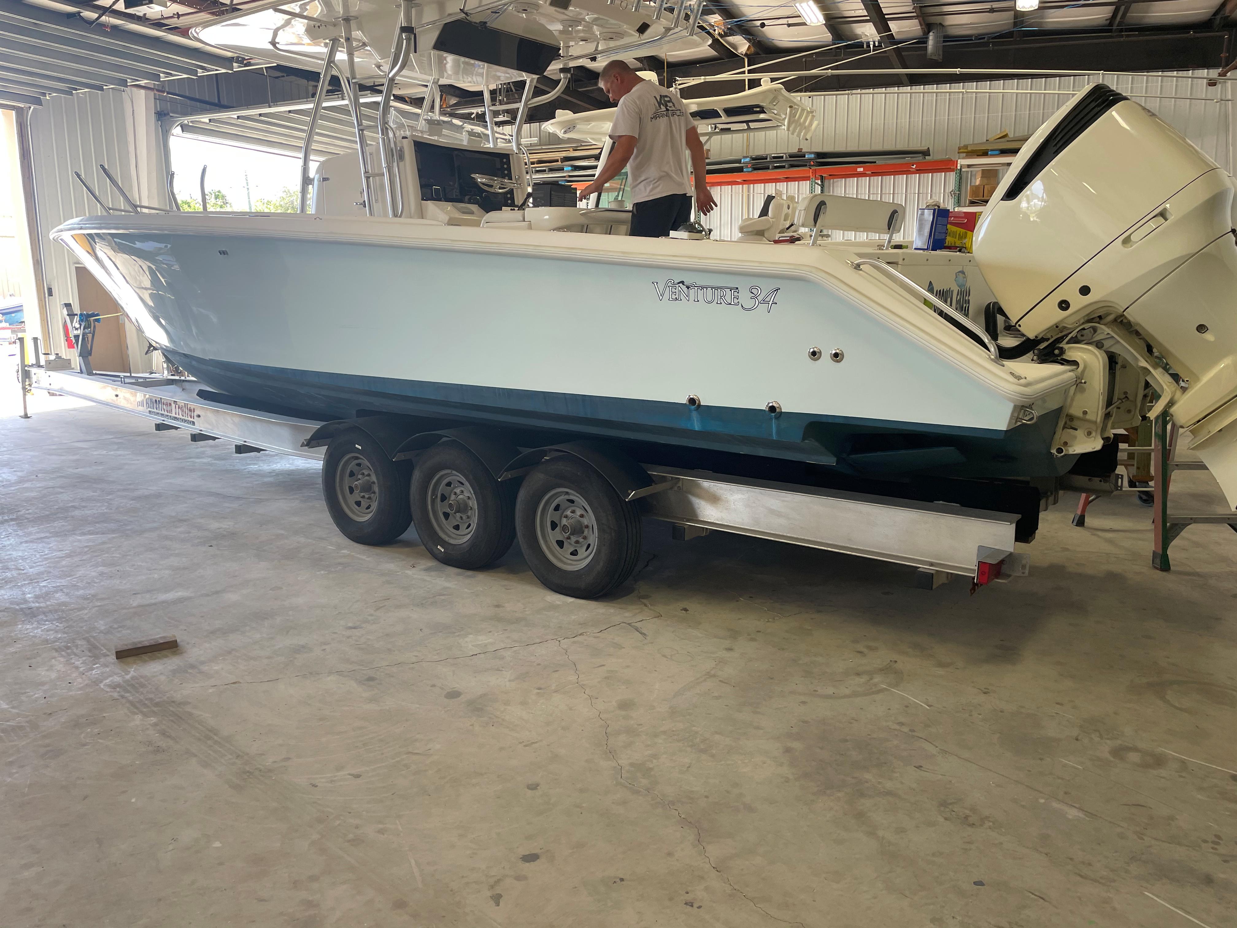 2004 Venture 34 Open boat on trailer in a garage setting.